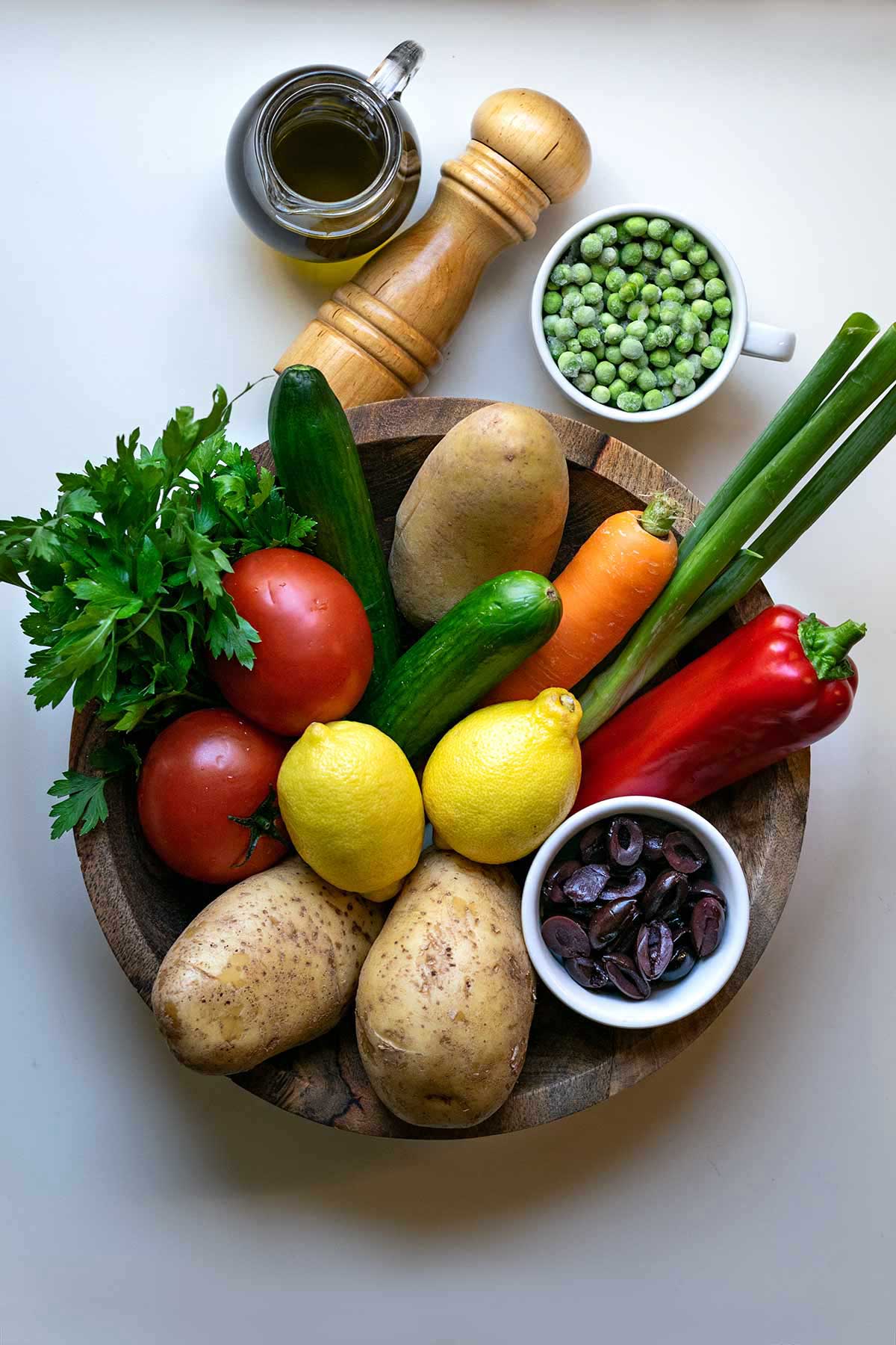 Image showing a bowl with the ingredients for the Greek potato salad.