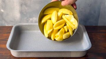 Potato wedges transferred into a baking dish.