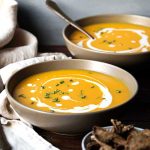 Two bowls of butternut soup with sweet potato.