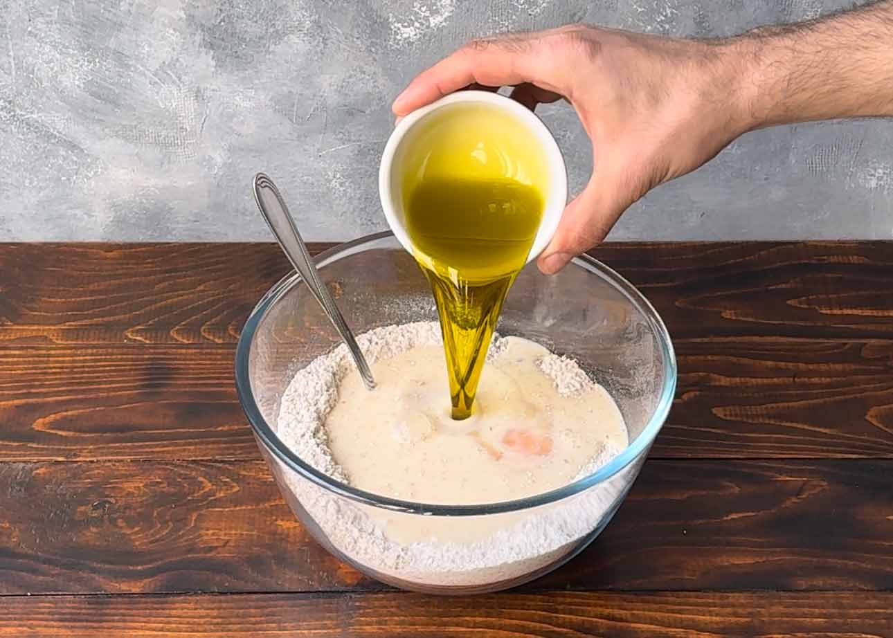 Adding the olive oil to the dry ingredients.