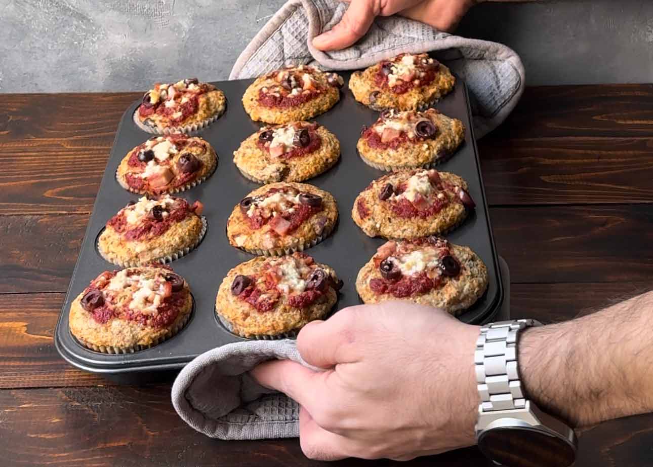 Freshly baked savory muffins in a muffin tin.
