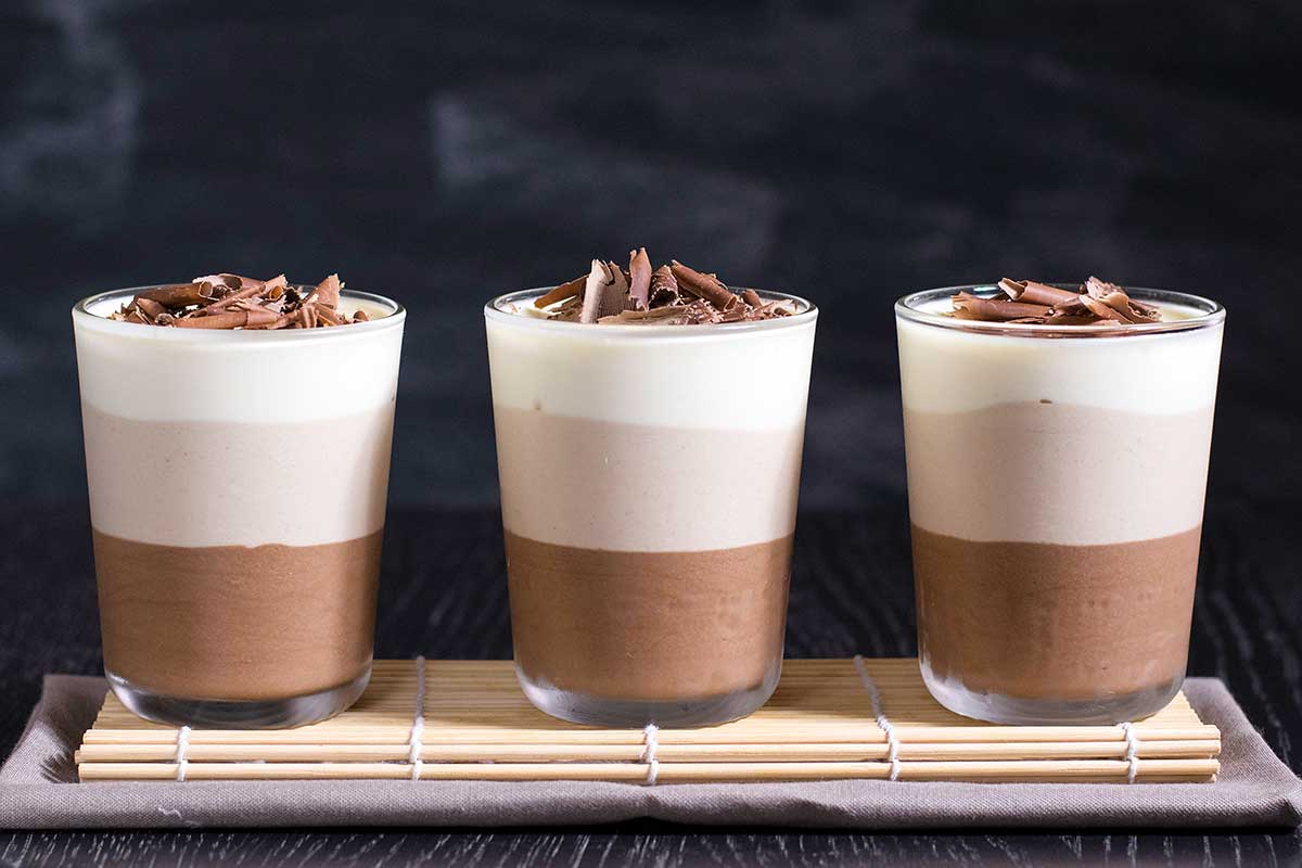 chocolate_trilogy_dessert_2 3 glasses with chocolate mousse with whipped cream.