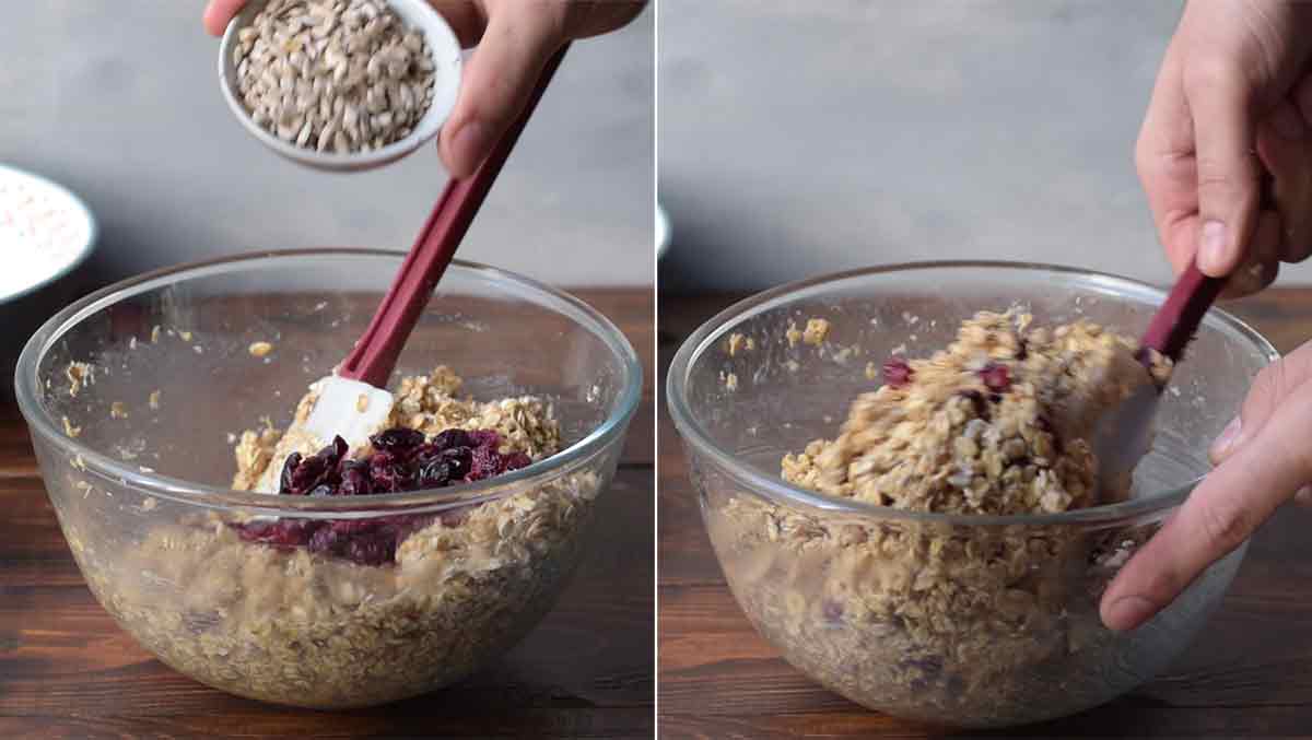A hand adding sunflower seeds to the bowl with the oat mixture.