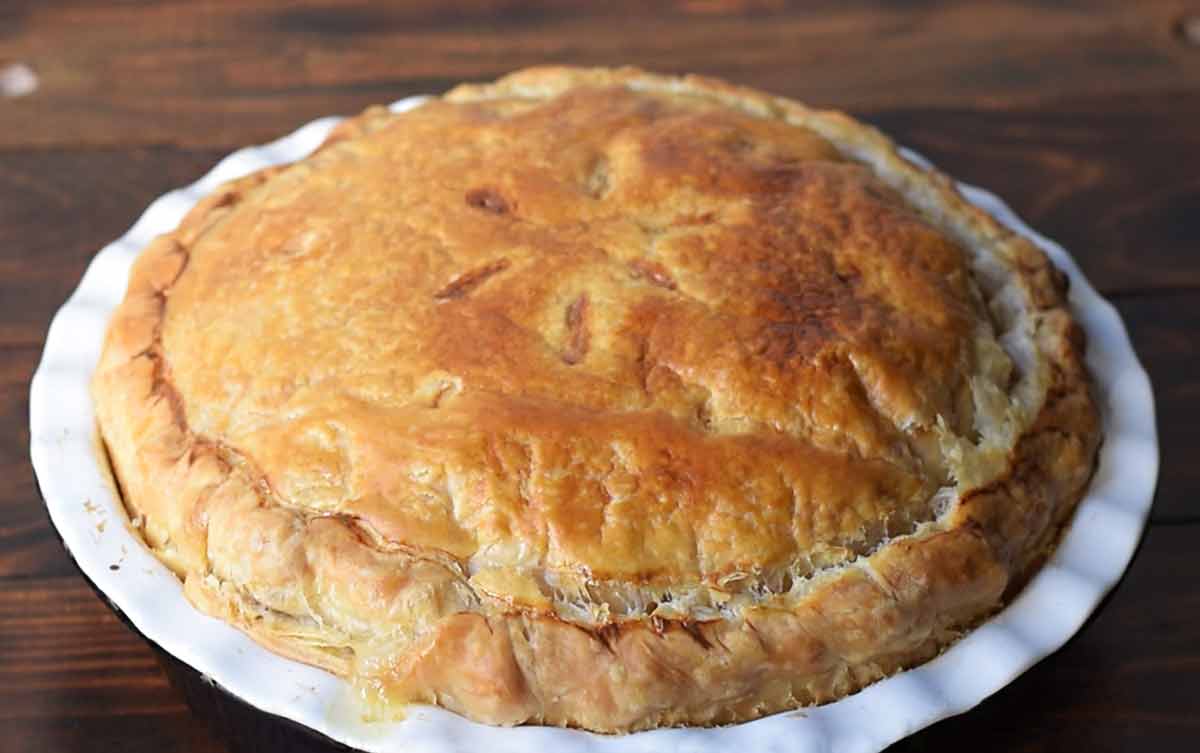 A baked chicken pot pie in a classic pie dish.