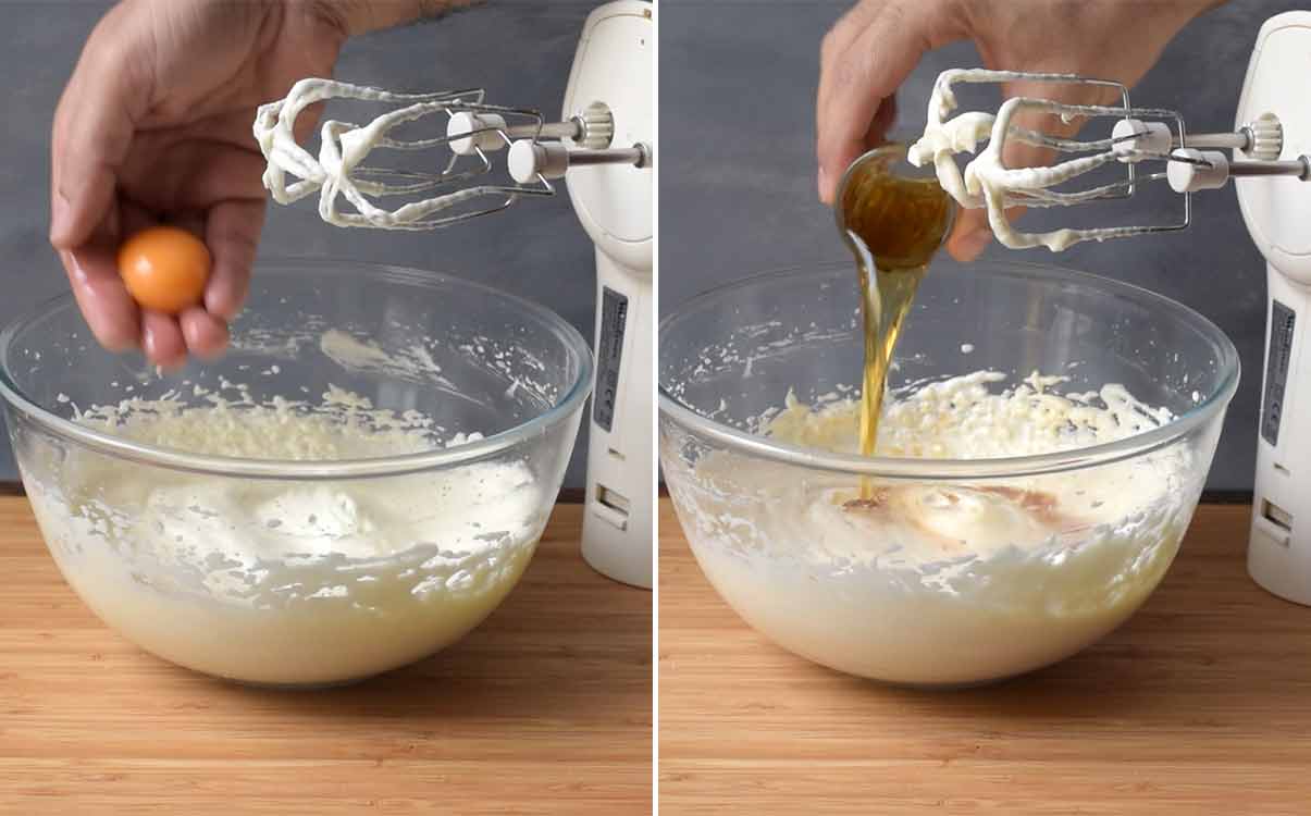 A hand adding an egg yolk and cognac to a bowl with butter mixture.