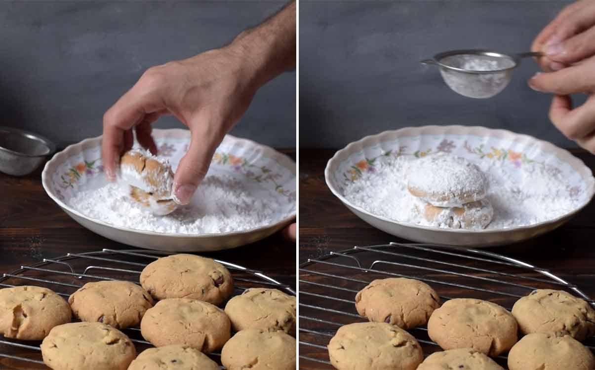 A hand rolling the cookies in icing sugar and a hand holding a sieve with icing sugar.