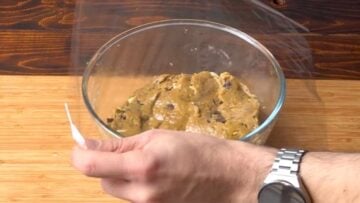 Pistachio chocolate chip cookie dough going into the fridge.