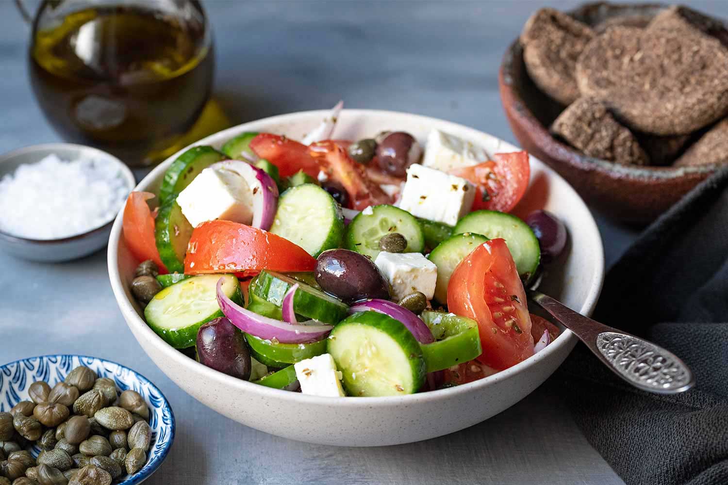 45 angle image of a bowl filled with Greek salad also known as Horiatiki.