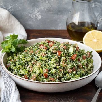 A deep plate with Tabbouleh salad.