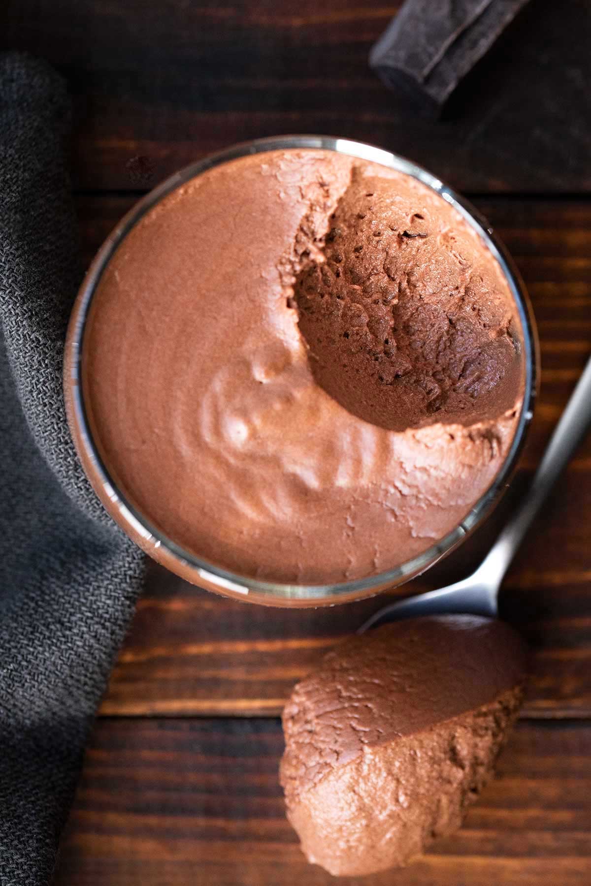 A glass with choc mousse half eaten.