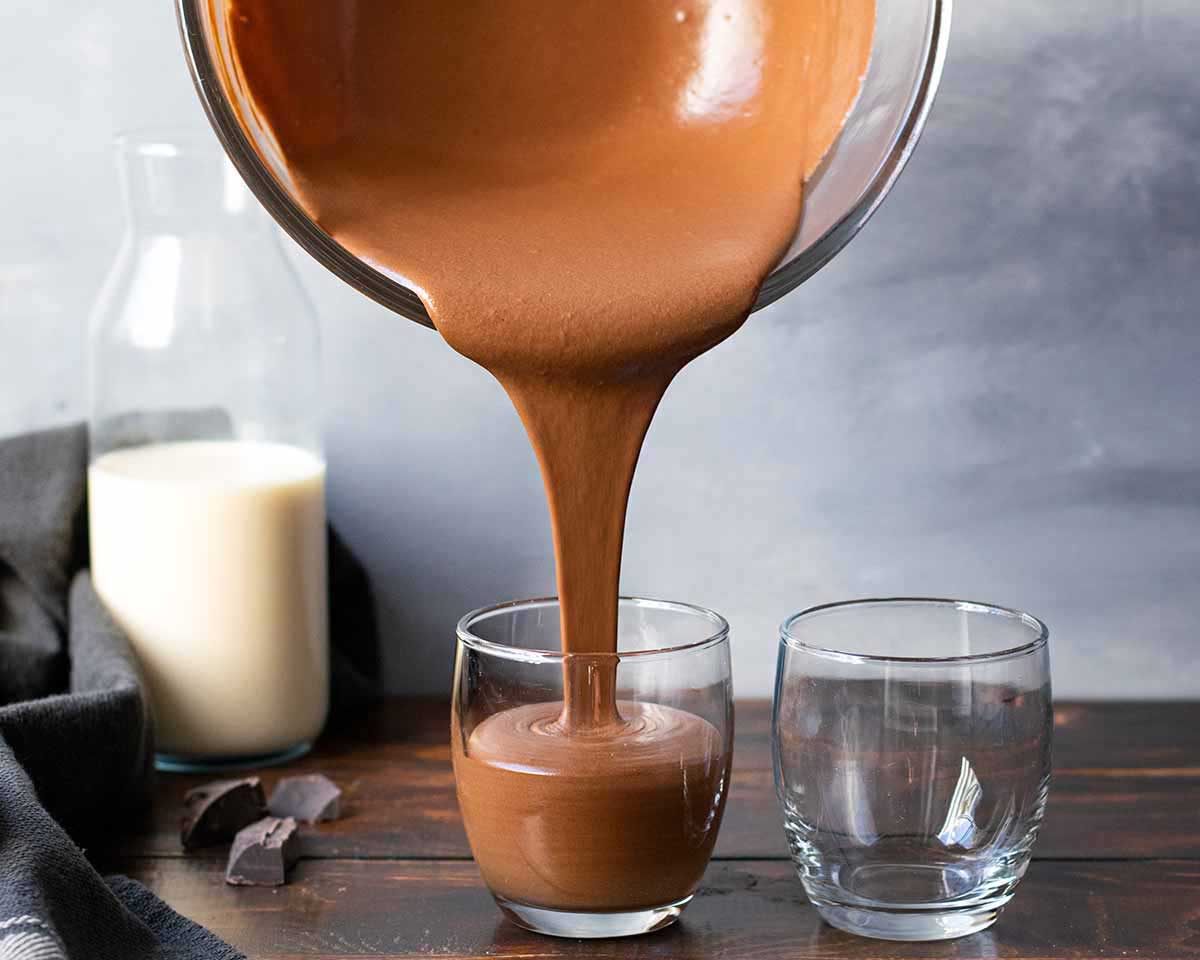 Dividing the mousse between the individual serving dishes.
