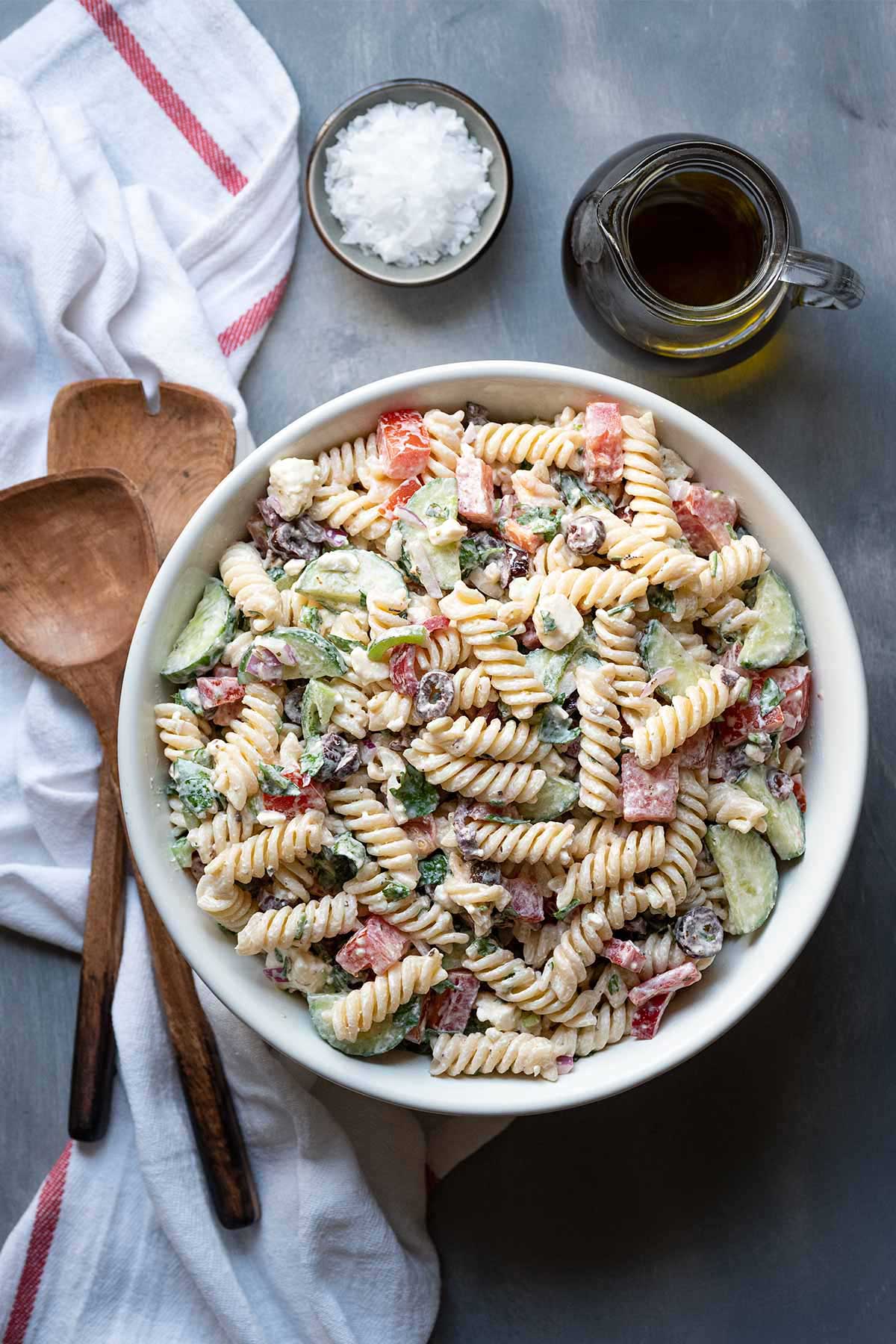 Vertical image of Greek pasta salad with feta and creamy yogurt dressing.