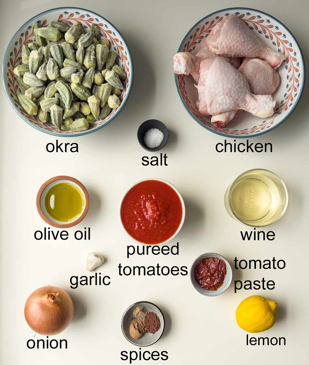 Labeled ingredients for okra stew with chicken and tomato sauce.