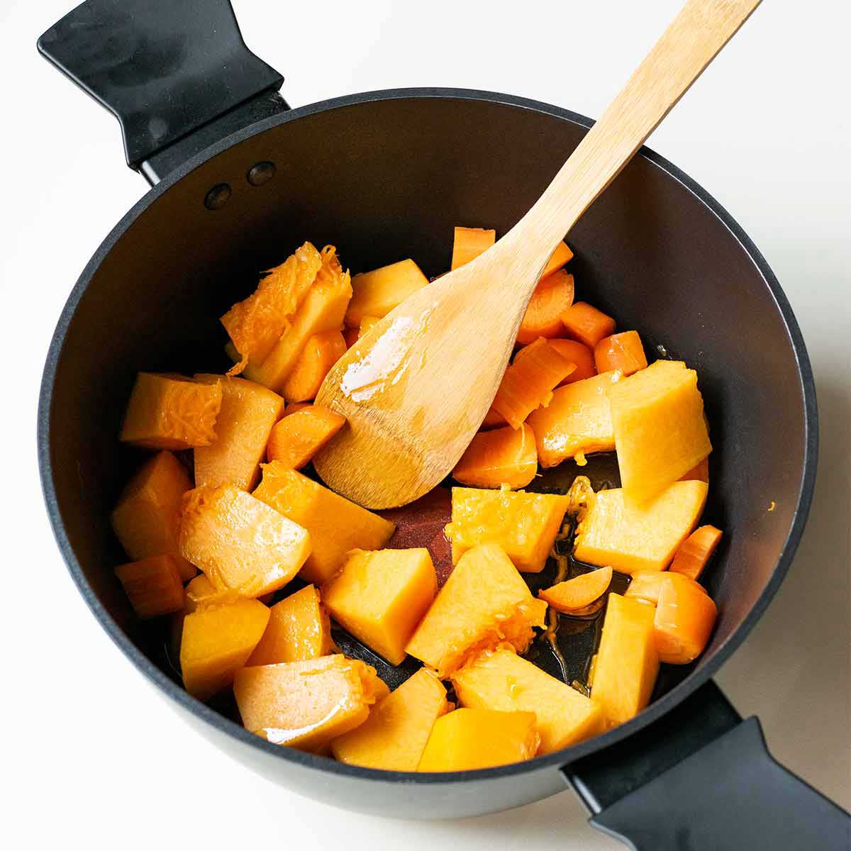 How to sauté the pumpkin in a pot with olive oil until caramelized.