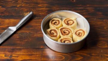 Small batch cnnamon buns in a baking pan before baking.