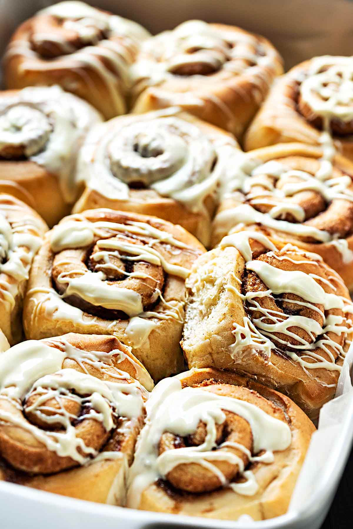 Dairy free cinnamon rolls with olive oil and white chocolate frosting.