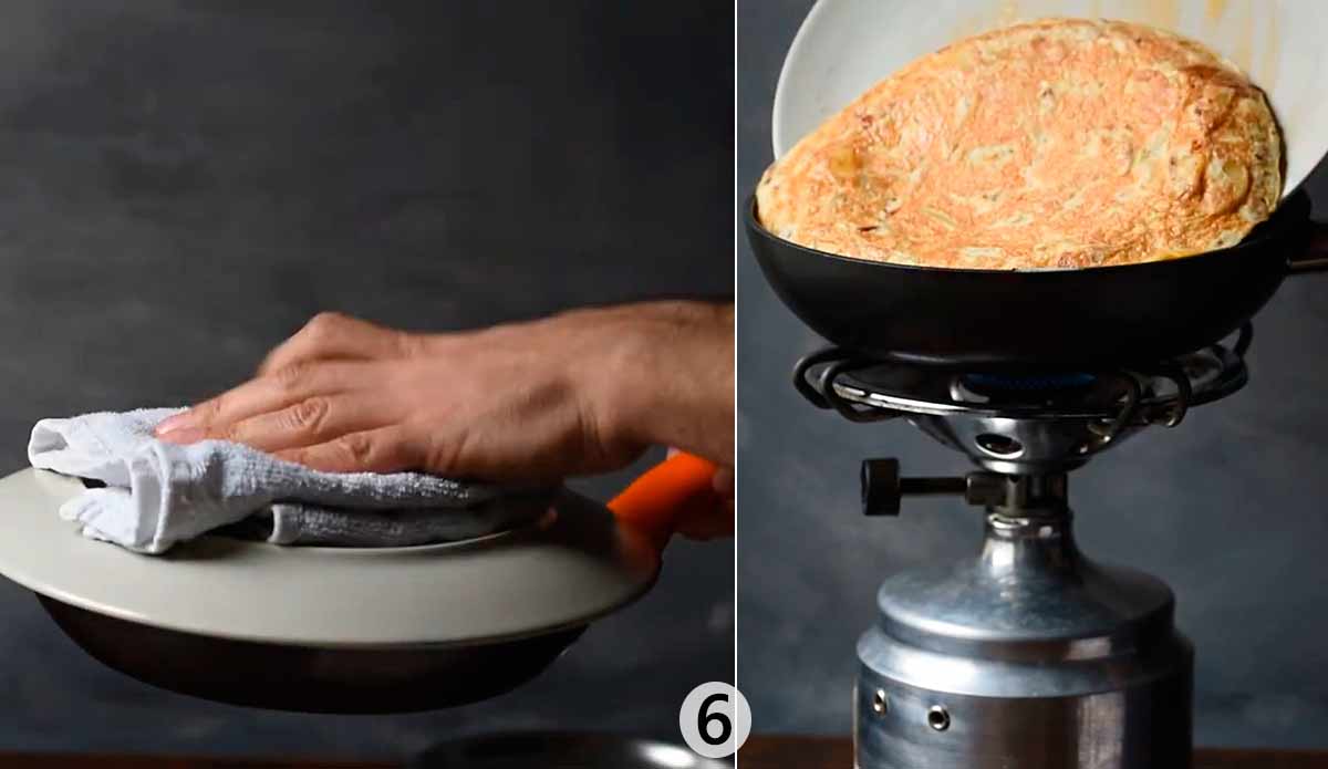 Two hand holding the pan and flipping the omelette.