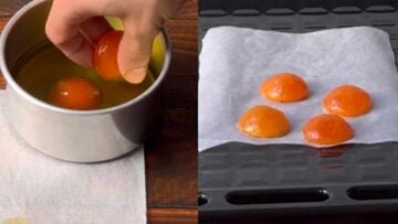 A hand placing the yolks in a baking dish with olive oil.