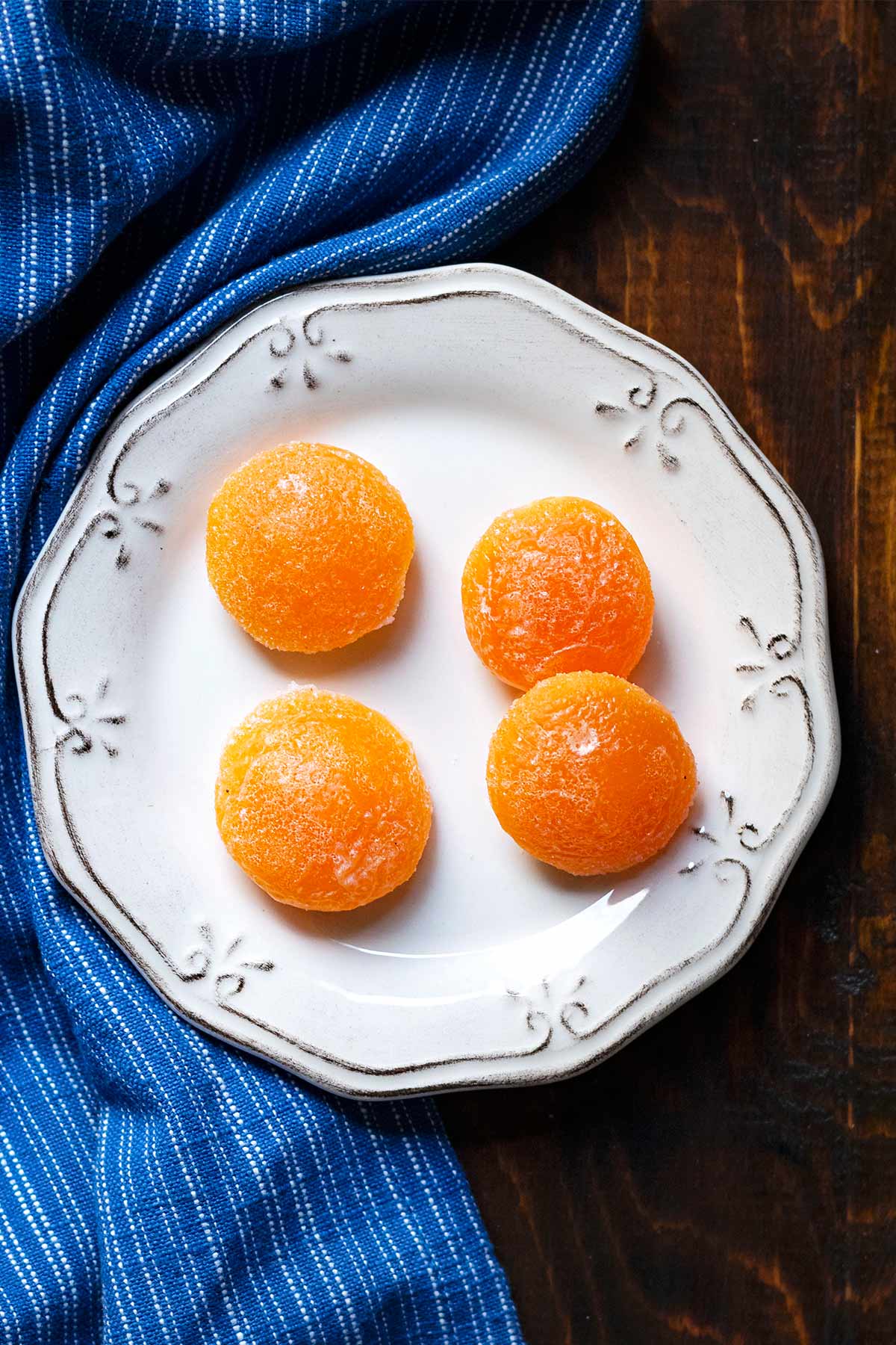 4 salt cured egg yolks on a plate.