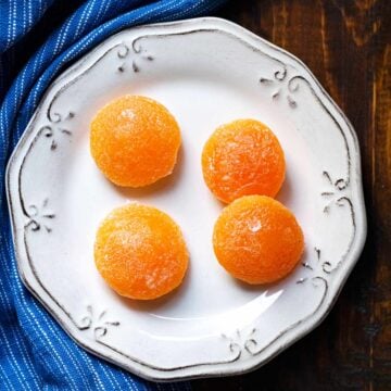 4 salt cured egg yolks on a plate.