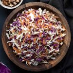 A wooden bowl with Greek cabbage salad.
