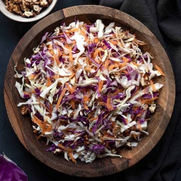 A wooden bowl with Greek cabbage salad.