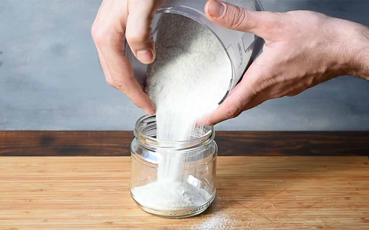 Vanilla sugar poured from the food processor into a glass jar.