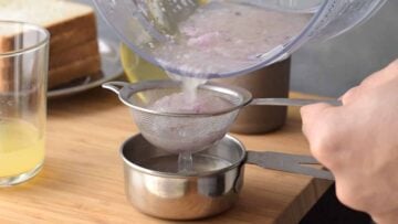 Grated onion passing through a sieve.