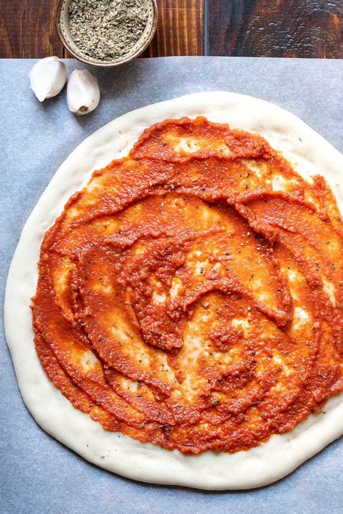 tomato sauce on pizza dough.