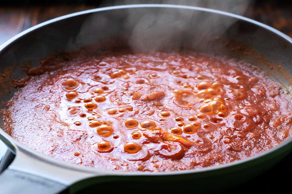 pizza sauce cooking in a saucepan.