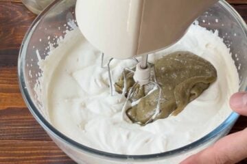Adding the pistachio base to the whipped cream.