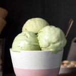 3 scoops of pistachio ice cream in a bowl.