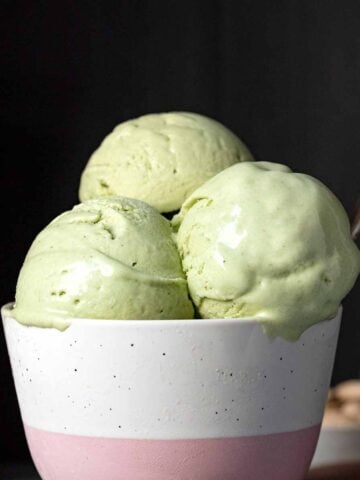 3 scoops of pistachio ice cream in a bowl.