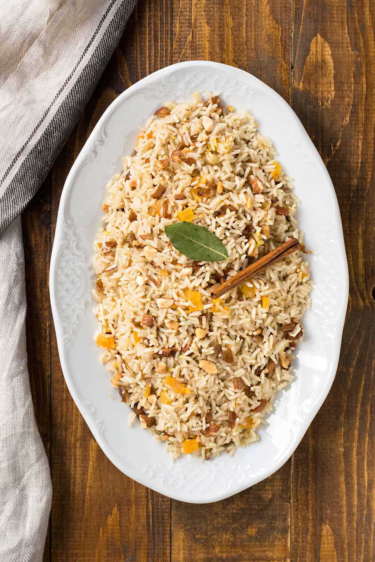 This is a photo of a plate with Moroccan rice pilaf with saffron, raisins, dried fruit and almonds.