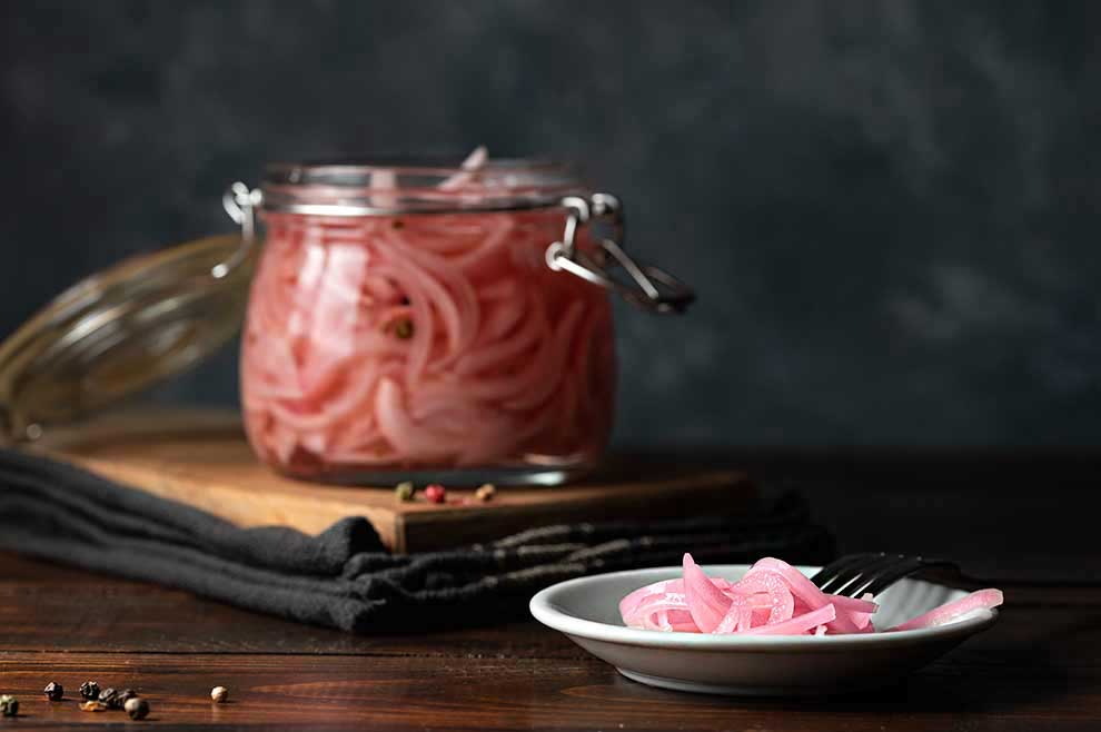 pickled red onions in a jar.