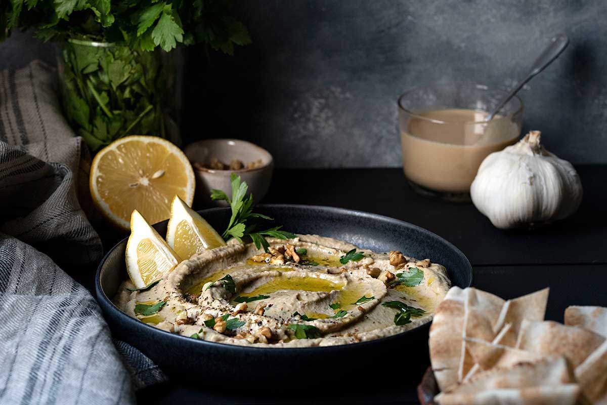 Baba ganouj (eggplant dip) served on a plate with a drizzle of olive oil.