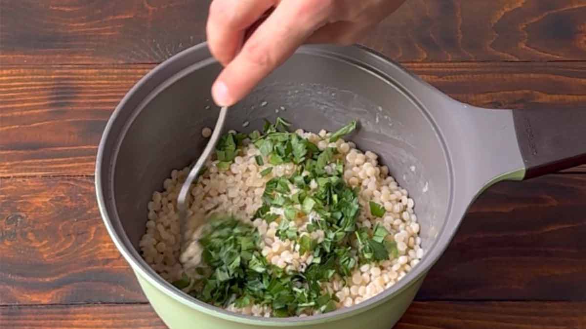 Adding the parsley and fluffing up the couscous.