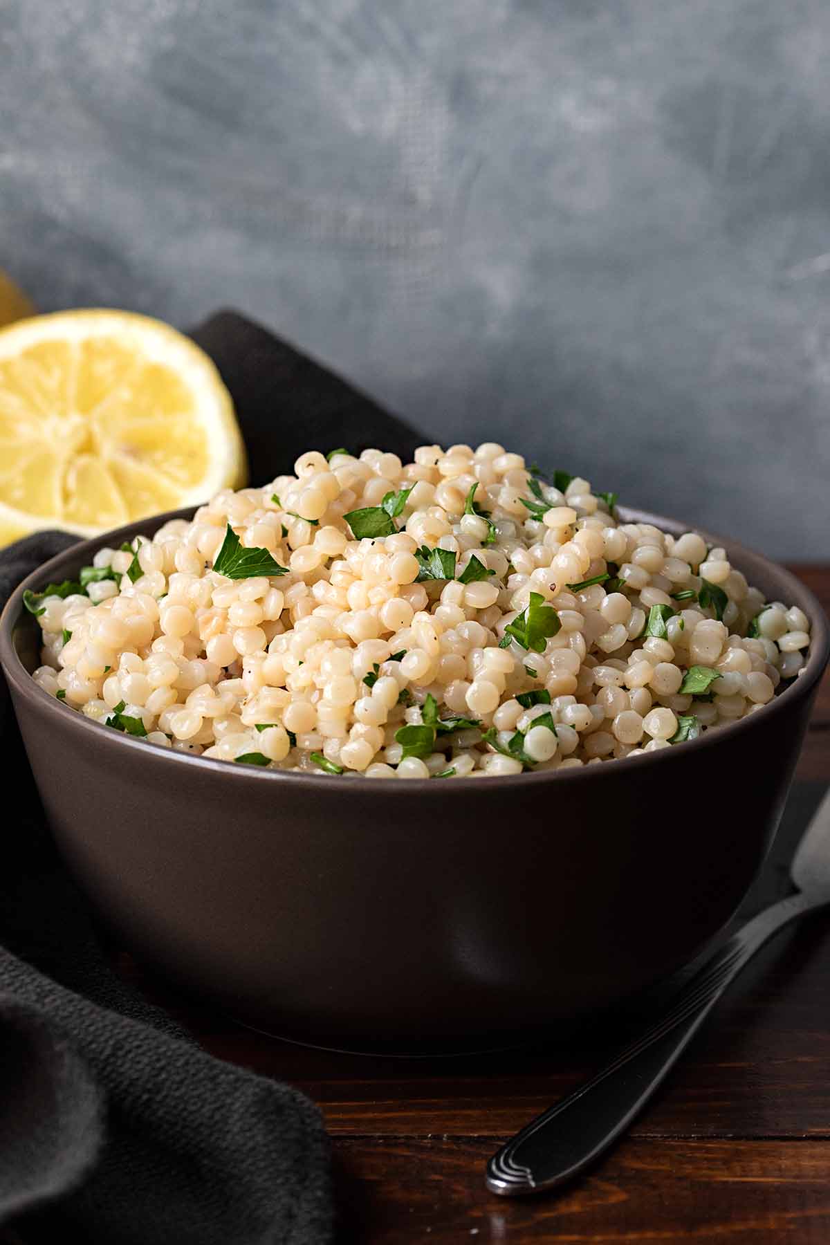 A bowl filled with lemon garlic pearl couscous.
