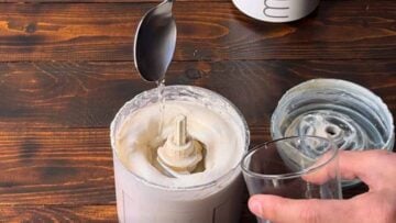 Adding water when making the tarama dip.
