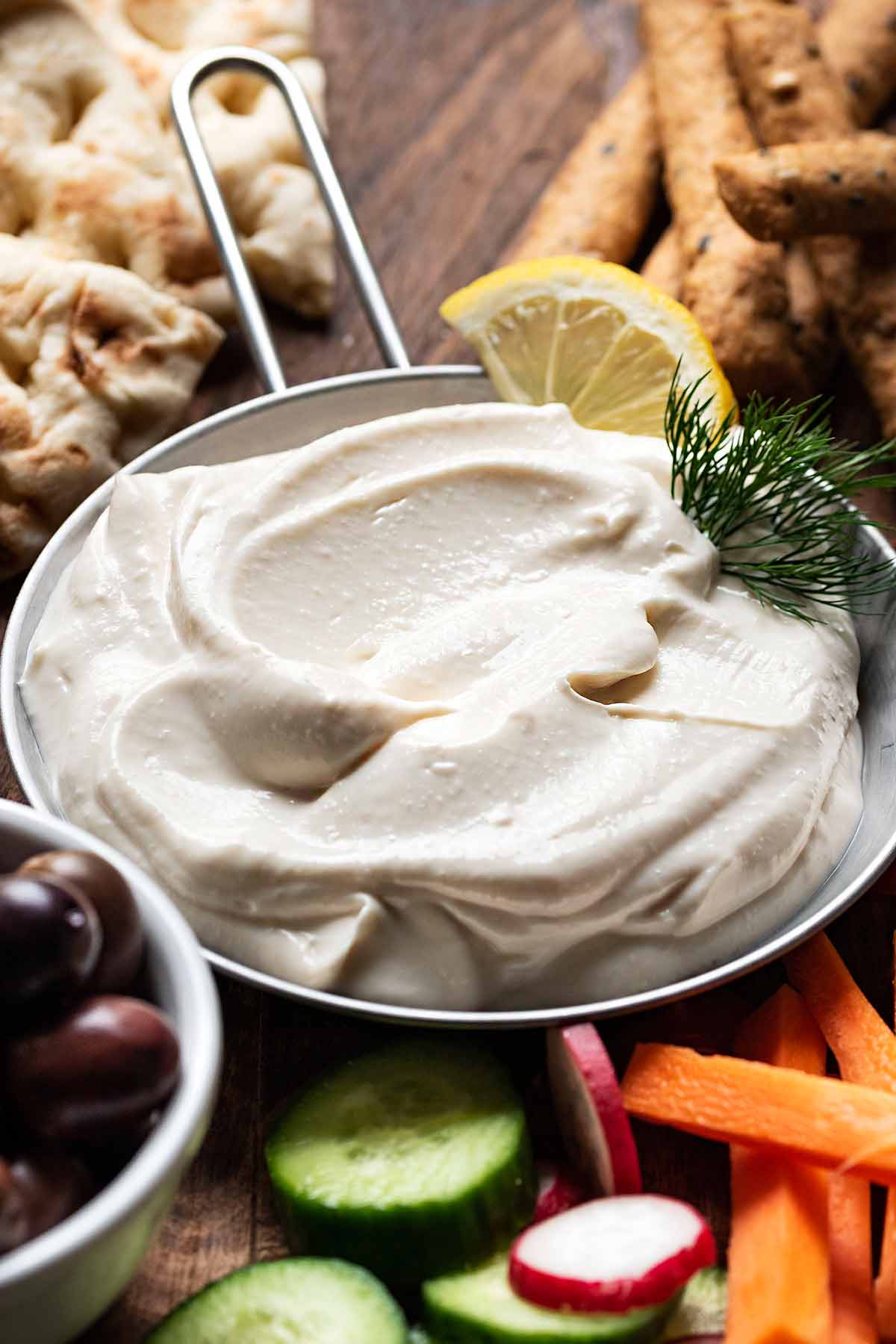 Taramosalata without bread served with vegetables and pita bread.