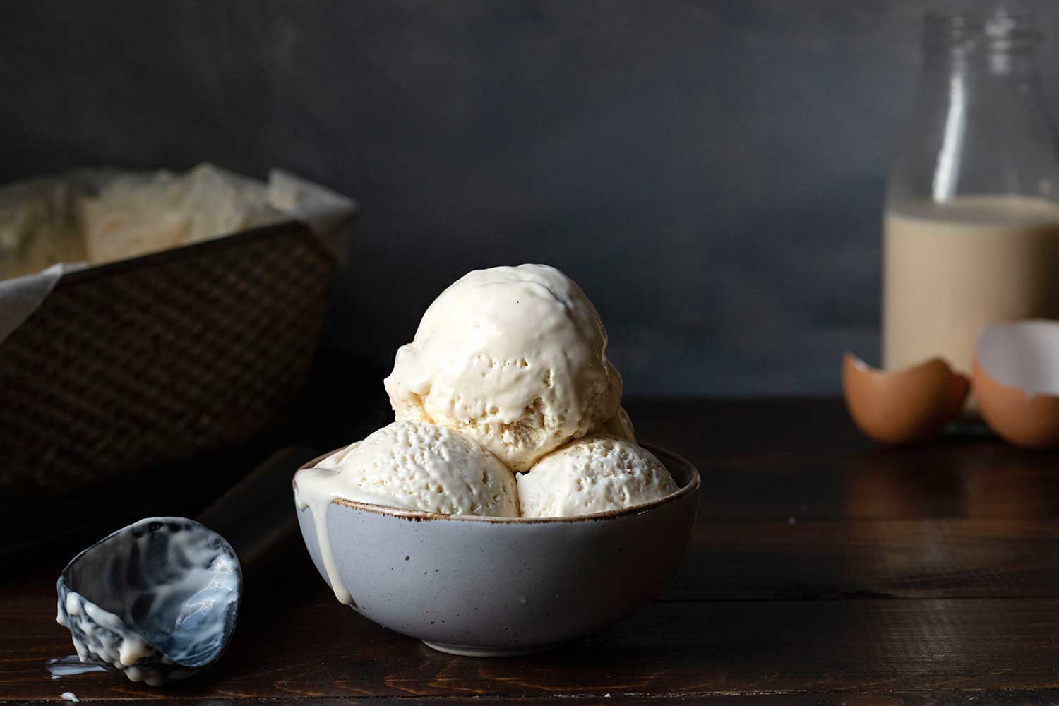 3 scoops of no-churn, homemade vanilla ice cream served in a bowl.