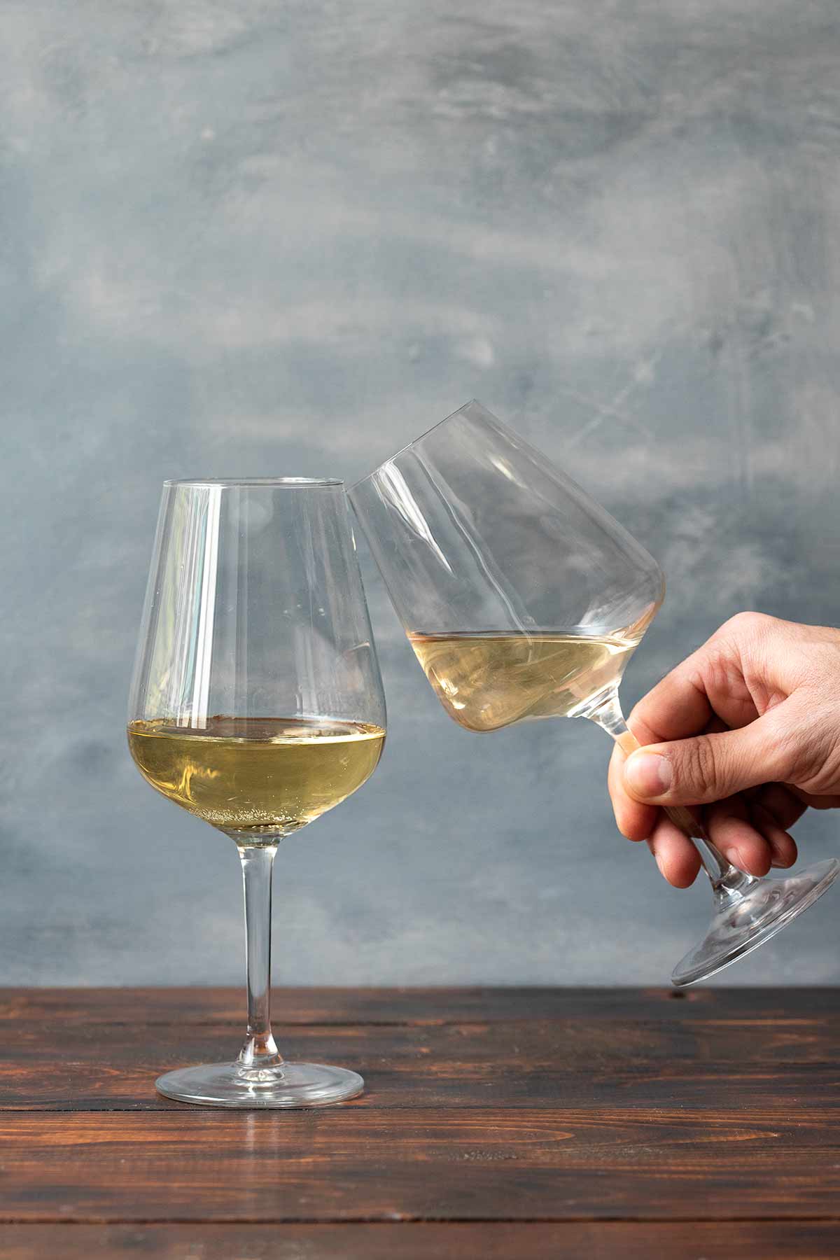 Two bottles with white wine. The one with Chenin Blanc and the other with Chardonnay.