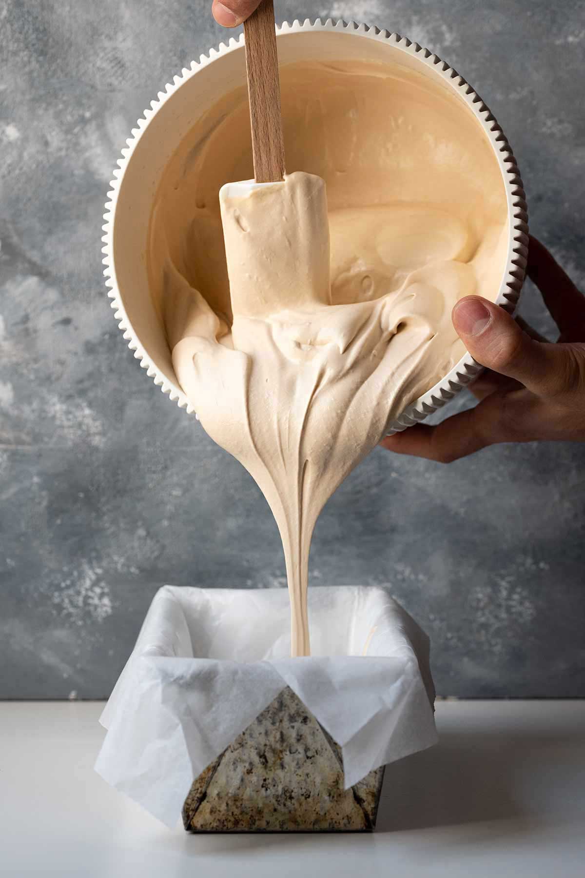 Pouring the coffee ice cream mixture to a container for freezing.