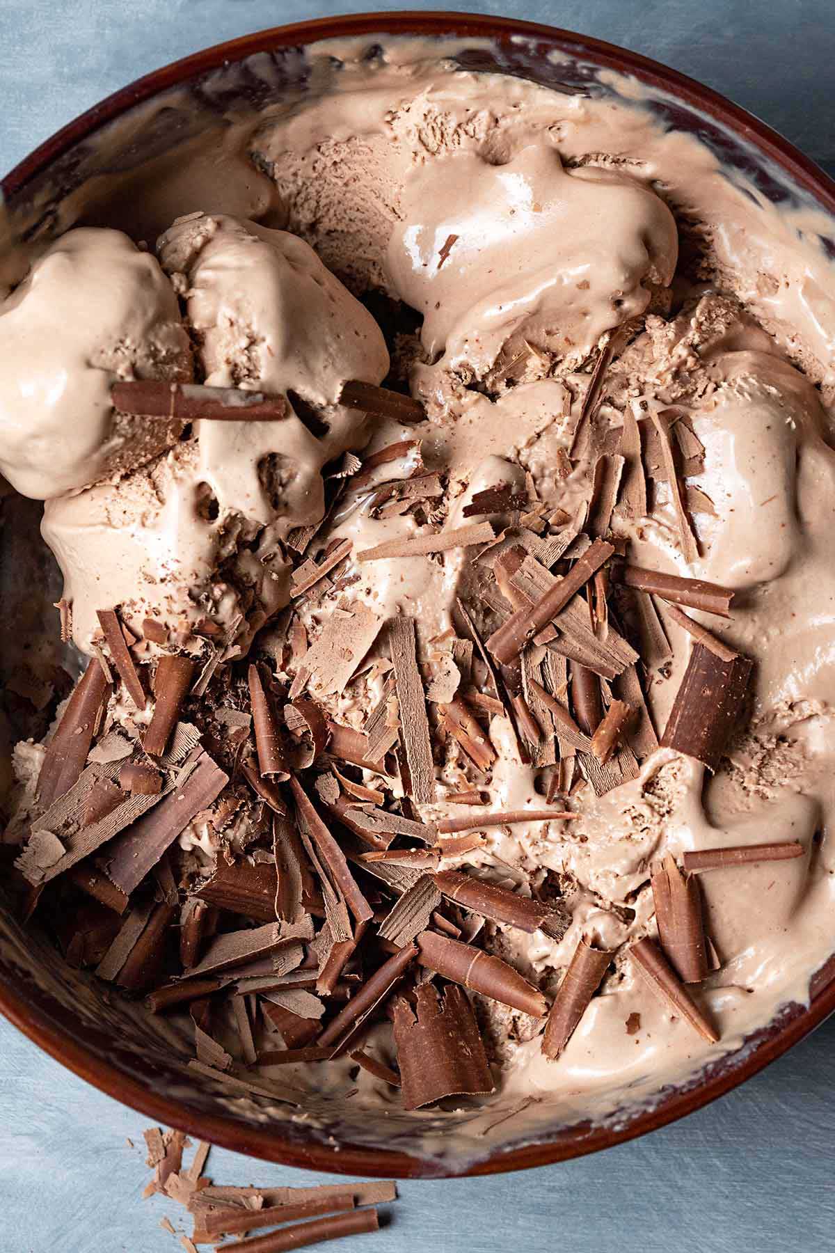 A bowl full of coffee chocolate ice cream (mocha flavor) with dark chocolate shavings on top.