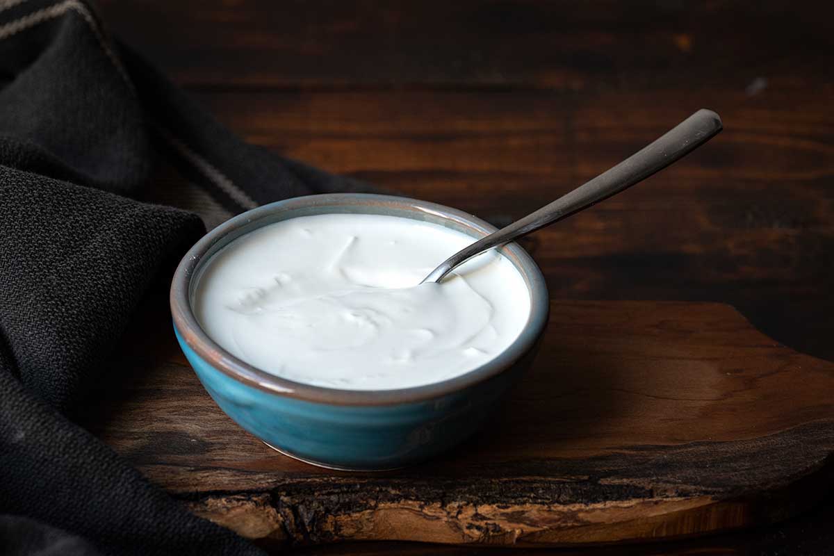 Image showing a bowl with plant-based yogurt (such as coconut yogurt) as a dairy-free Greek yogurt substitute.