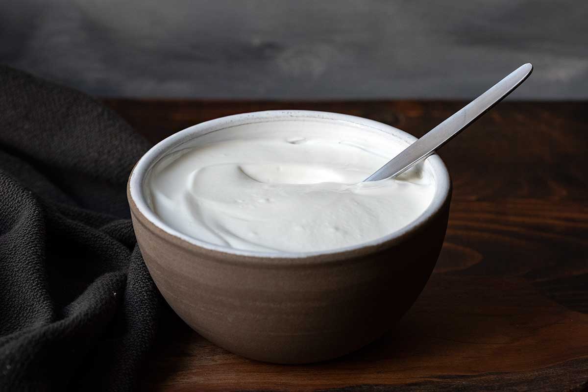 Image showing a bowl of regular yogurt as a dairy Greek yogurt substitute.