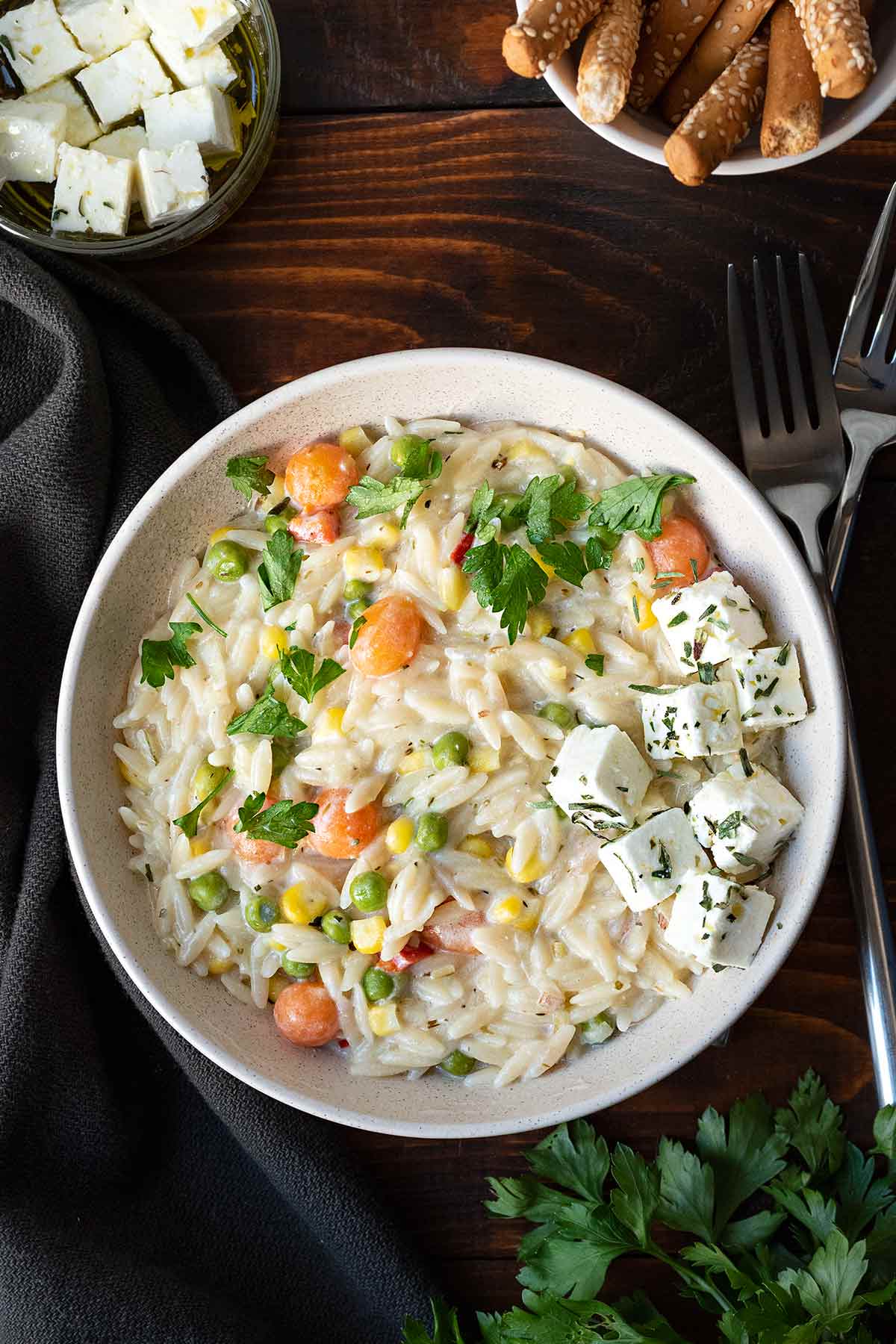 Vegetarian orzo pasta in a bowl with feta cheese.