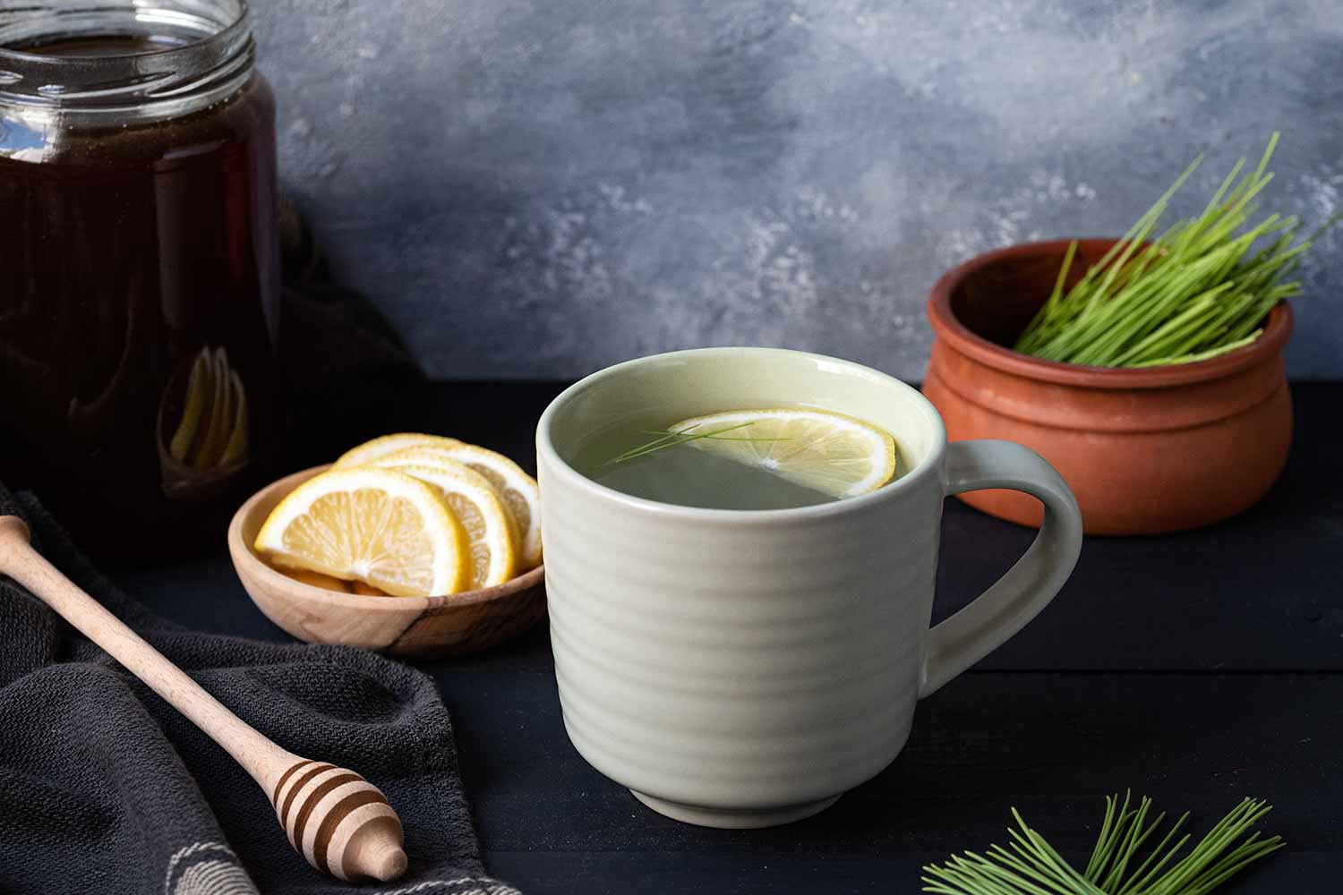 Landscape image of a cup of pine needle tea.