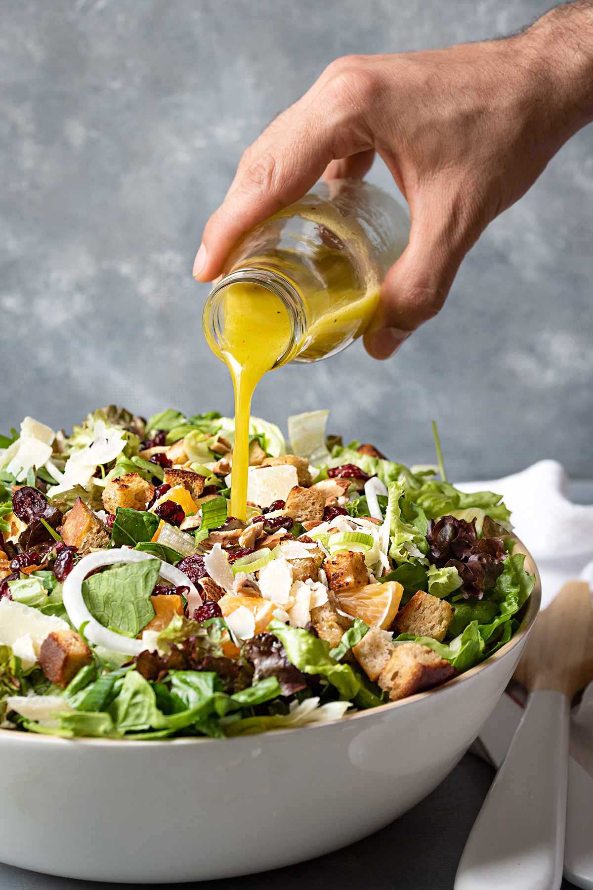 Image showing pouring the dressing over the green salad.