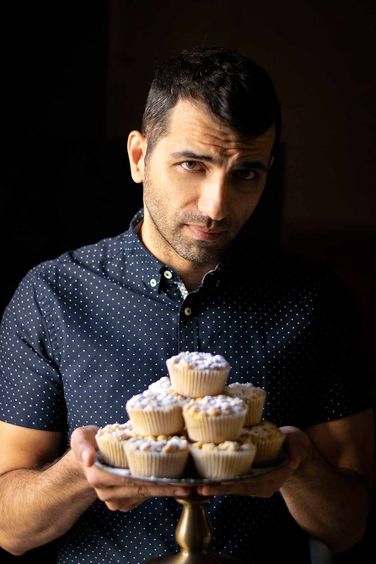 Makos form The Hungry Bites blog, holding a tray with muffins.